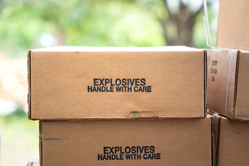 Stack of the explosive material carton box which is label as handle with care text on it. Weapon...