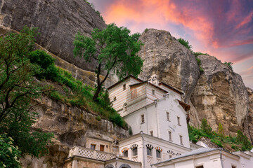 The house in the rock. The house is in the mountain. A house among the rocks. A stone house.