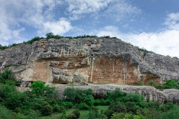 Caves in the rocks. A house in the rocks. A pen for animals in the rocks. An ancient structure. Life in the mountains. Life in the rocks.