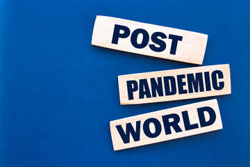 Wooden blocks with words Post-pandemic world. New normal social and business concept.