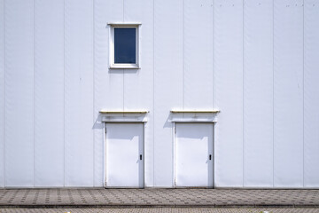 Obraz na płótnie Canvas two white doors in white facade