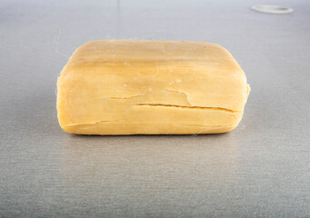 Single bar of obsolete soap. Isolated on white background. Close-up.