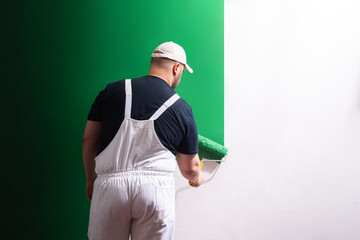 Painter man at work with a paint roller