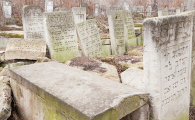 old tombstones on Jewish cemetery with Hebrew inscriptions