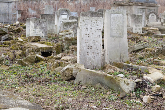 Abandoned tombstones on Jewish cemetery with Hebrew inscriptions