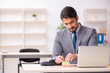 Fototapeta premium Young male employee working in the office