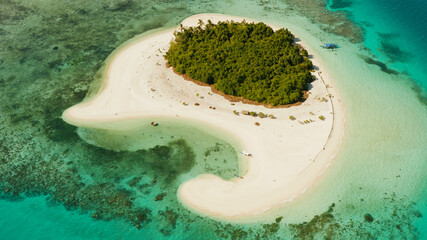Tropical landscape: small island with beautiful beach, palm trees by turquoise water view from above. Patawan island with sandy beach. Summer and travel vacation concept.