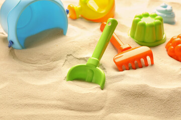 Fototapeta na wymiar Colorful beach toy kit on sand. Outdoor play