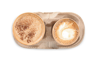 Takeaway paper cups with coffee in cardboard holder on white background, top view