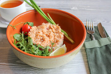 Close-up of a salad with trout and herbs