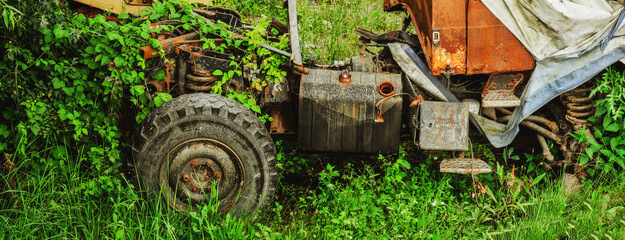 a rusty truck left in the grass