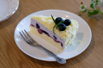 Double blueberry cheese cake on white plate.