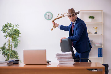 Young cowboy businessman working at workplace