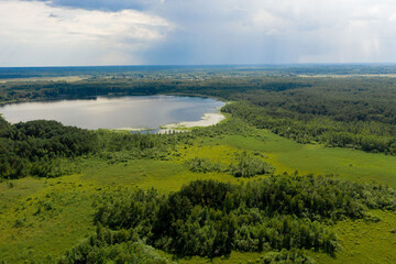 Fototapeta na wymiar Aerial view of large country lake for fishing, aerial photo. The concept of active, eco-and photo-tourism