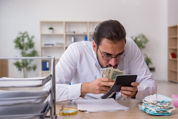 Young male bookkeeper in budget planning concept