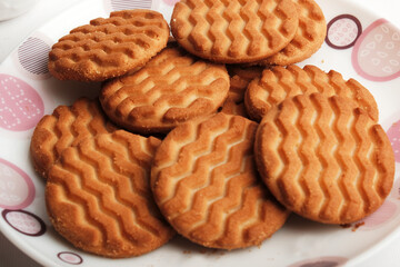 Wheat biscuits in the white plate, Atta biscuit, cookies - close up of a fresh breakfast cookies.