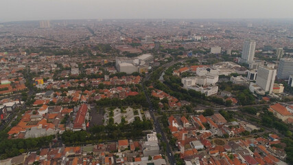 Aerial cityscape modern city Surabaya with skyscrapers, buildings and houses. sunset in city skyline with skyscrapers and business centers Surabaya capital city east java, indonesia