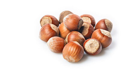 Ripe wild hazelnuts. Stack of hazelnuts on a white background. Filbert nuts. Natural organic product. Copy space. Close-up. A place for your text. Food banner format.