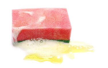 Yellow liquid, detergent puddle, foam with bubbles and red sponge isolated on white background