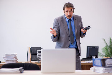 Young male employee in industrial espionage concept