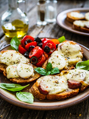 Tasty sandwiches - baked bread with mozzarella, basil pesto and cherry tomatoes
