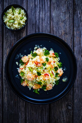 Risotto with shrimps and asparagus on wooden background
