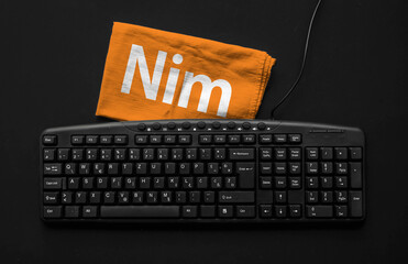 Nim programming language. Rag width word Nim and pc keyboard.
