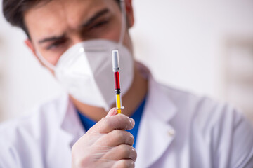 Young male doctor in vaccination concept