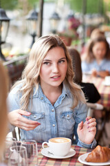 Women at cafe drinking coffee and talking. Communication and friendship concept.