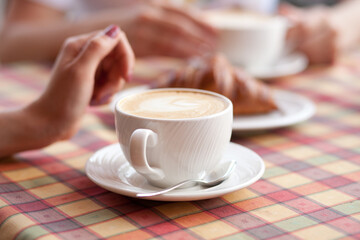 Women drinking a coffee in a cafe terrace