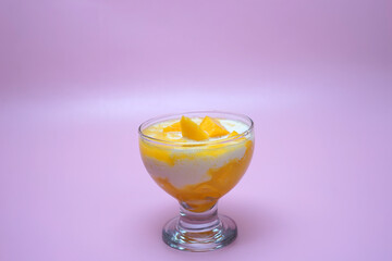 A glass of mango smoothie with milk 