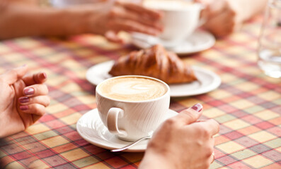 Women drinking a coffee in a cafe terrace
