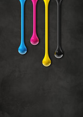 cmyk ink drops on black concrete background