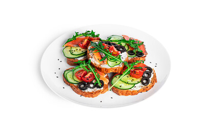 Bruschetta with cream cheese, salmon and vegetables isolated on a white background. Toasts isolated. Sandwich isolated. Sandwich with salmon and cheese.