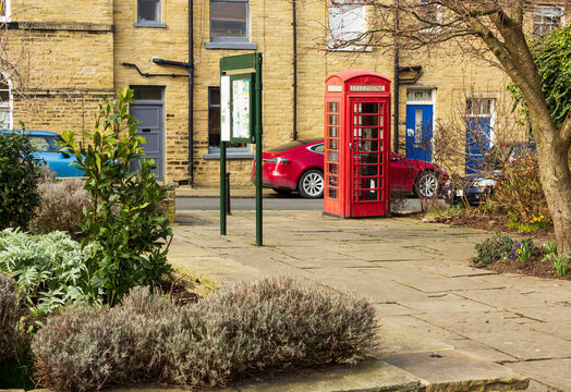 An old fashioned red telephone box stands on the corner of the garden created on the site of the old bath house in Saltaire