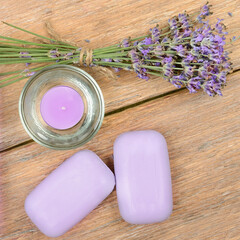 Fototapeta na wymiar lavender soap, scented candle, dried lavender flowers on a wooden background.