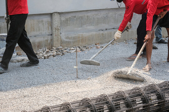 worker group adjust area cement road with gravel before repair concrete. heavy dirty mason job development team work