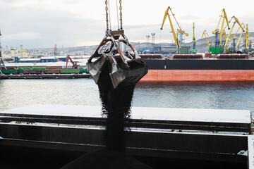 Clamshell gripper in the process of work in the Seaport.

Loading coal into the holds of a dry cargo ship at the Commercial Sea Port.