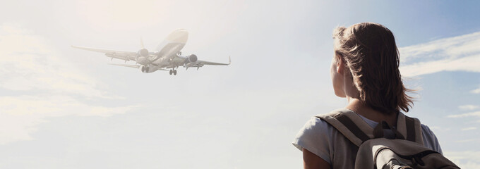 Woman looking at plane flying above the sea panoramic banner, travel, tourism, enjoy life and...
