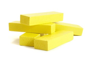 Stack of yellow wooden game blocks isolated on white background.