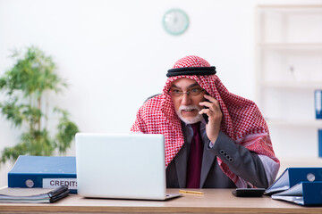 Male arab bookkeeper extremely tired with an excessive work