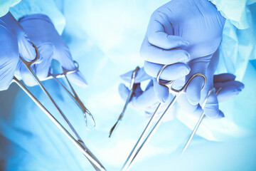 A group of surgeons is operating at the hospital, close-up of hands. Health care concept