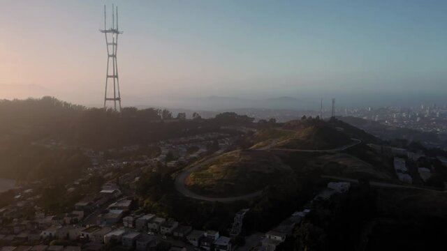 Aerial: Twin Peaks and Sutro Tower at sunset. San Francisco, California, USA
