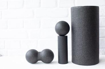 Foam roll, massage roll, balls on wooden background. MFR.
