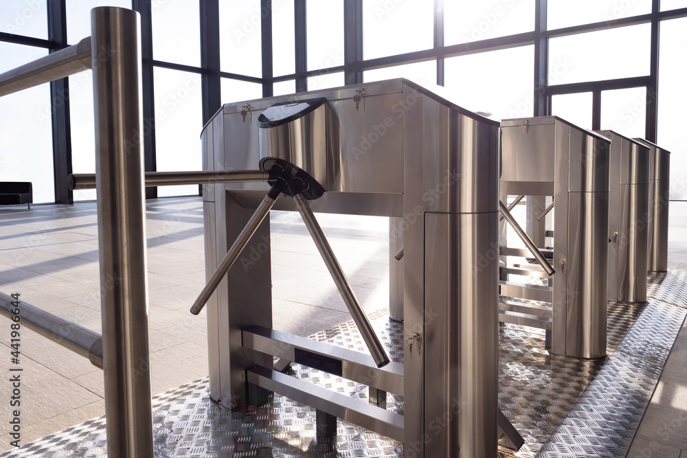 Poster electronic turnstile. access system to building. several turnstiles are installed nearby. check poin