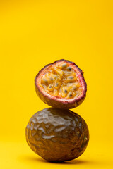 Maracuja or Brazilian tropical passion fruit studio food still life against a yellow background