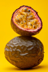 Pulp flesh showing in cut open Maracuja or Brazilian tropical passion fruit on top of another....