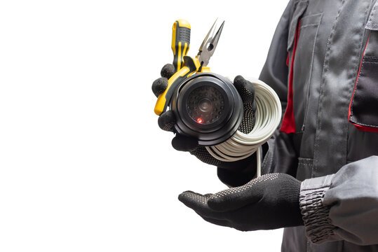 CCTV Security Camera And Work Tools In The Hands Close Up Isolated On The White Background.