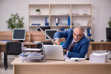 Old businessman employee after accident working in the office