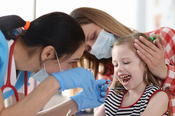 Doctor in protective medical mask taking buccal swab from little girl with cotton swab - obrazy, fototapety, plakaty